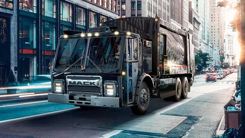 Mack LR Electric driving down a city street